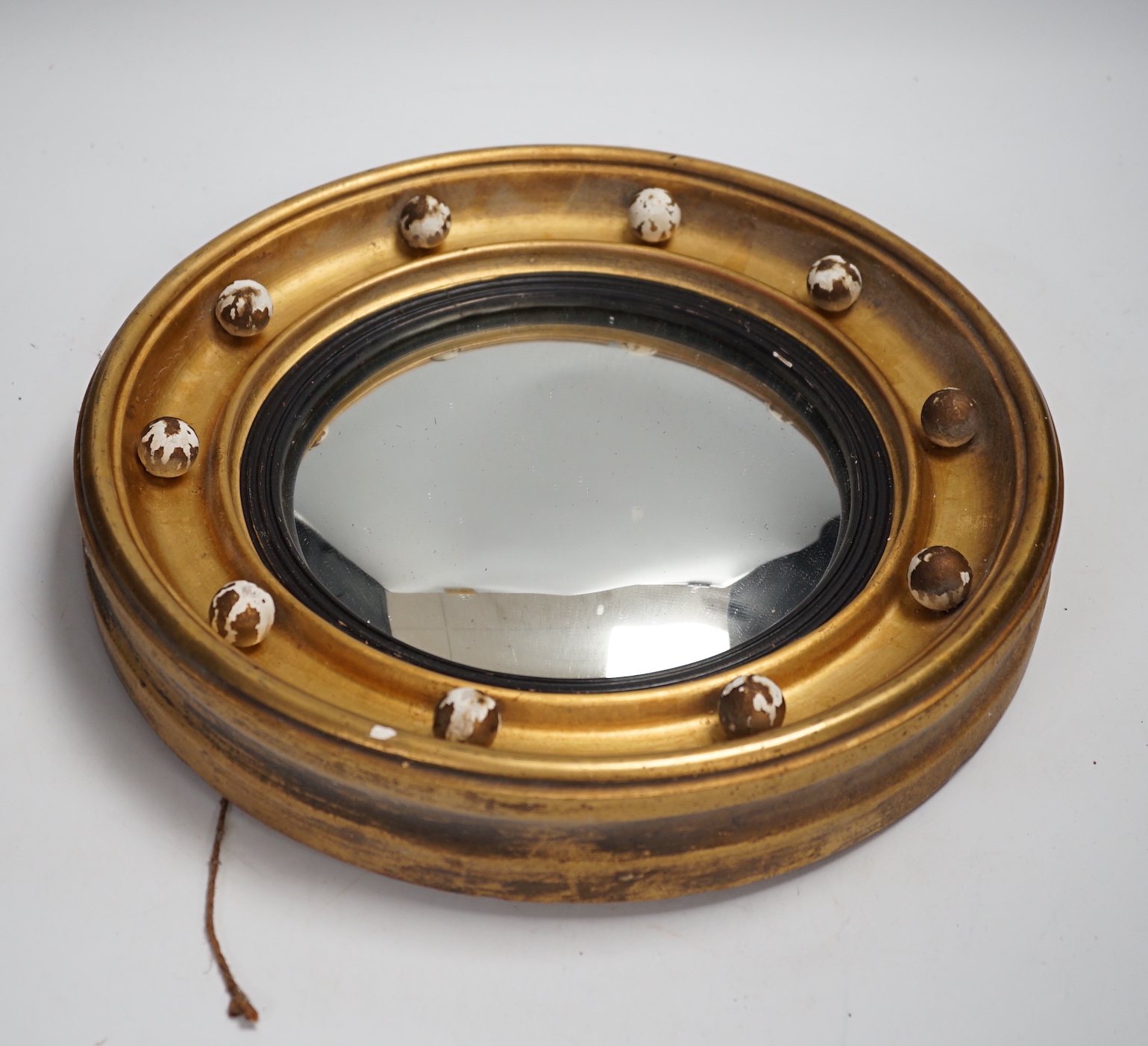 A small Regency style convex wall mirror, 31.5cm diameter